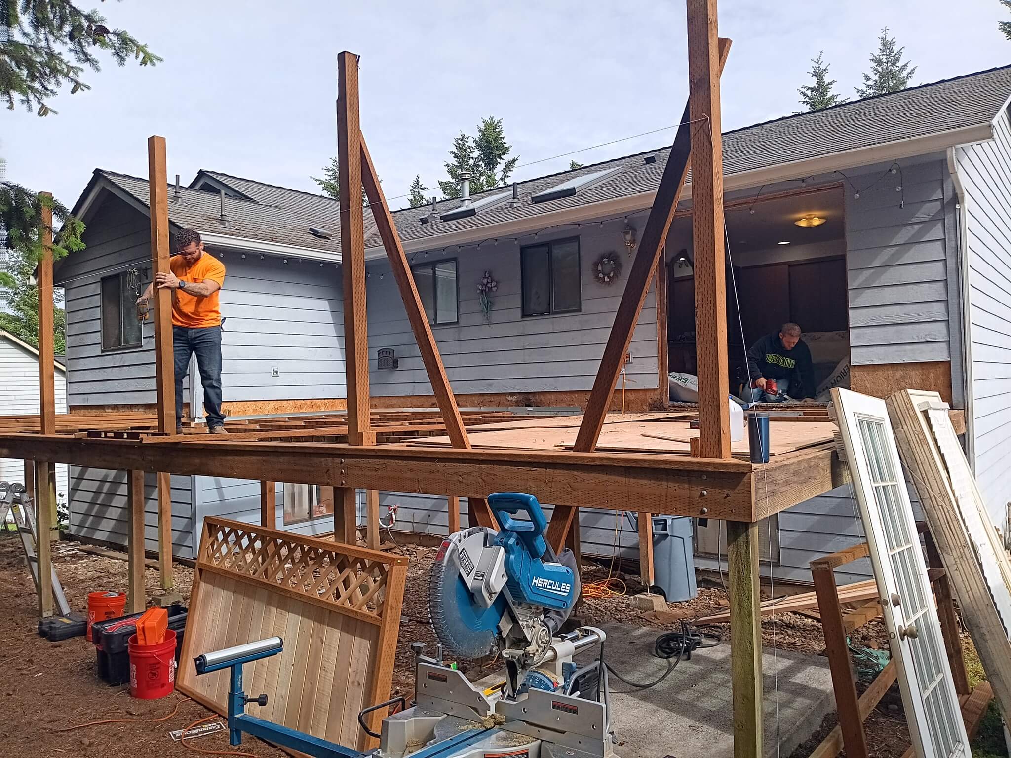 Best deck material for Oregon comparison Best deck material for Oregon showing composite decking installation with comparison to cedar and pressure-treated options