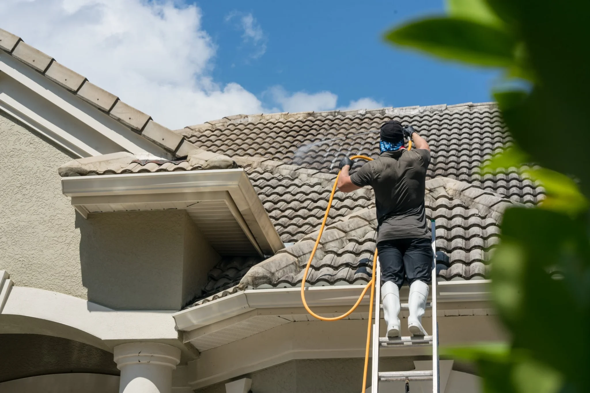 Prepare for pressure washing checklist and steps Homeowner preparing for pressure washing service by clearing driveway and patio furniture in Oregon
