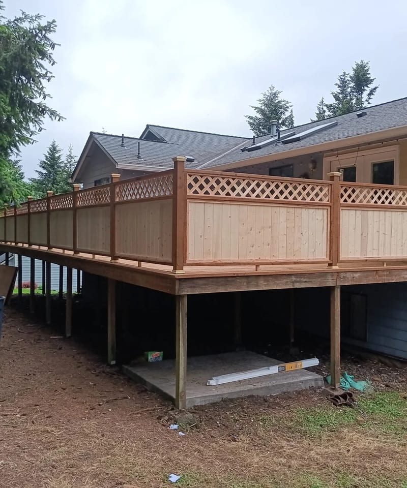 Elevated cedar deck with a lattice privacy rail on a Salem, Oregon home, built by On Top Home Services and affiliates — after treatment